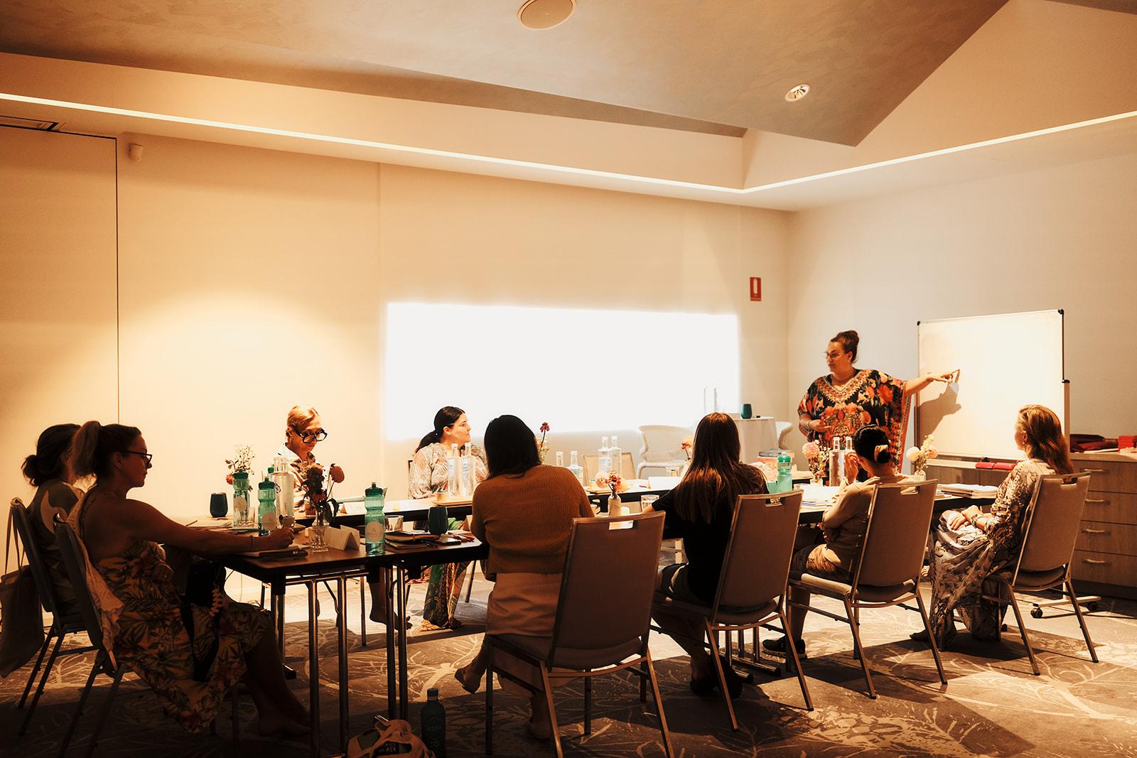 Vicky facilitating a group session, the women seated around tables
