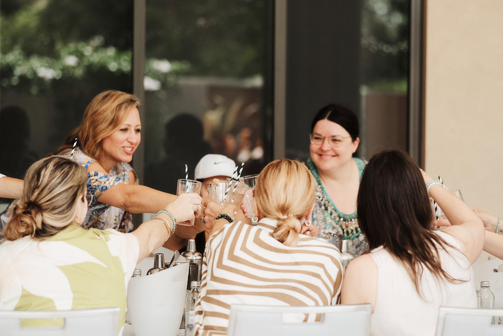 A close group of women sitting together, laughing