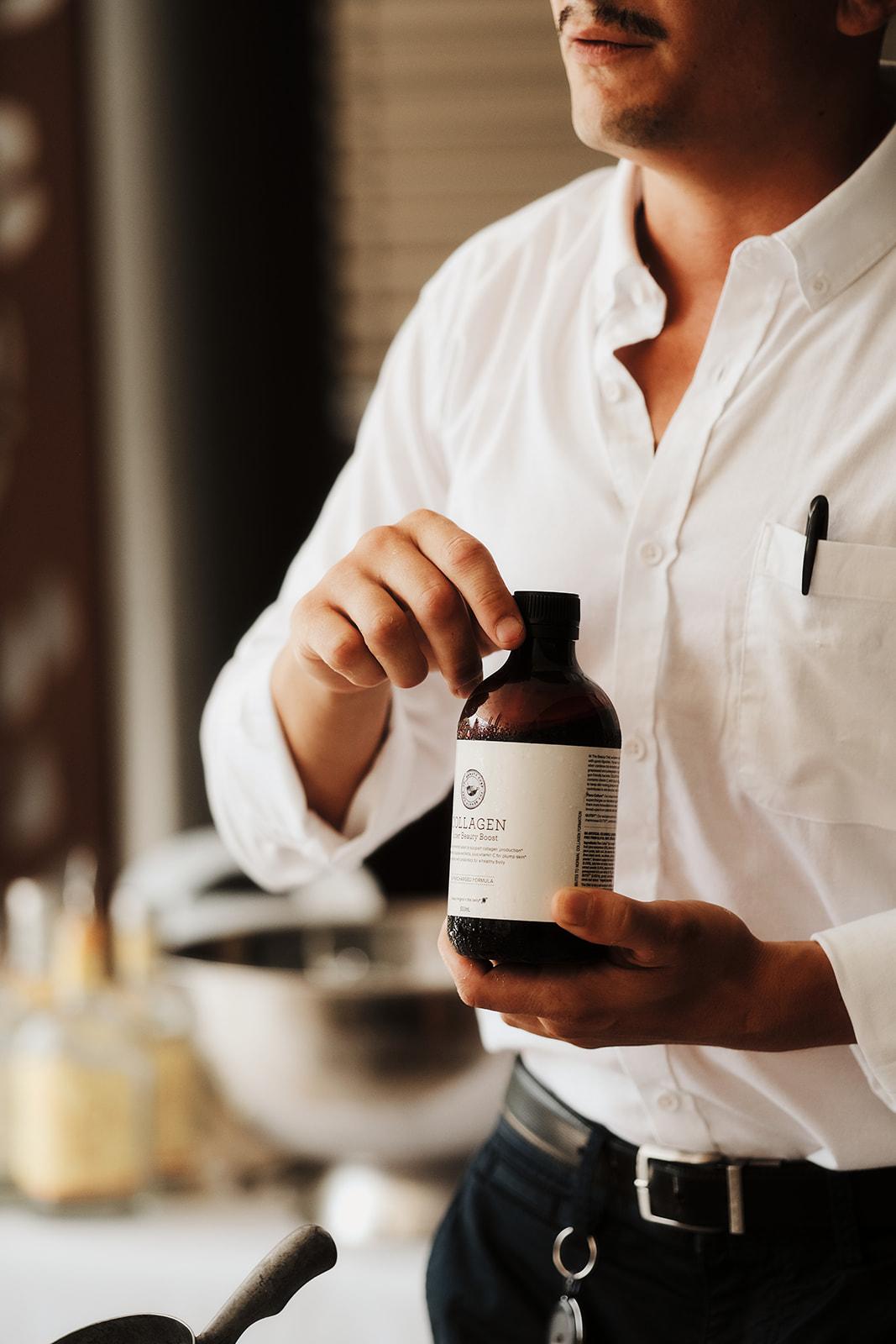 A bartender preparing an alcohol-free cocktail with a native wellness tonic