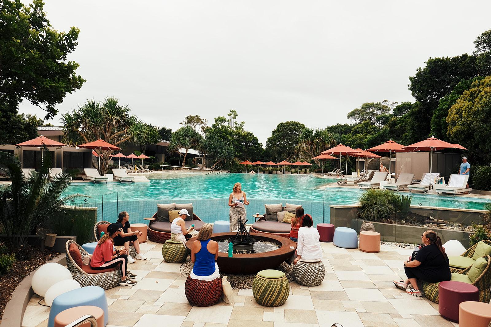 Daybeds and cushions set out around the pool for the retreat