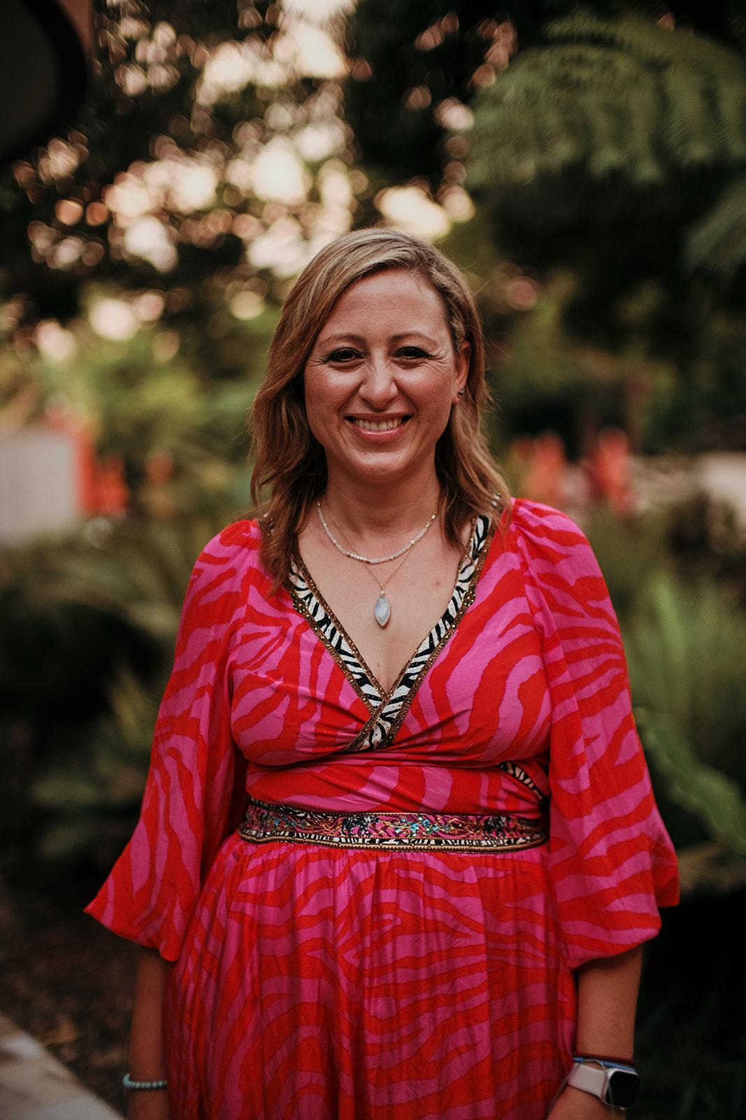 Portrait of a woman from the retreat in a red floral dress