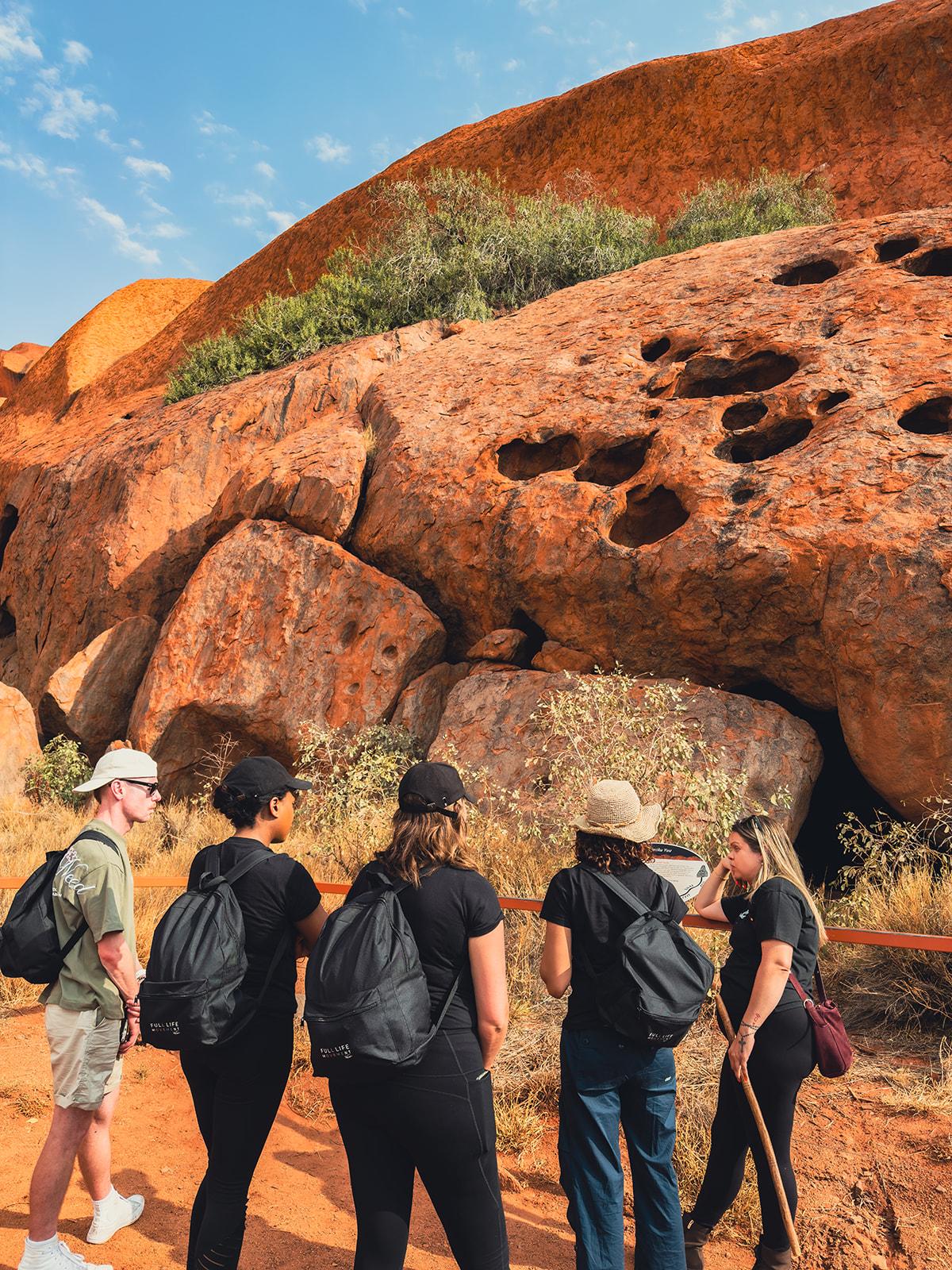 The group exploring rock formations together, backpacks on