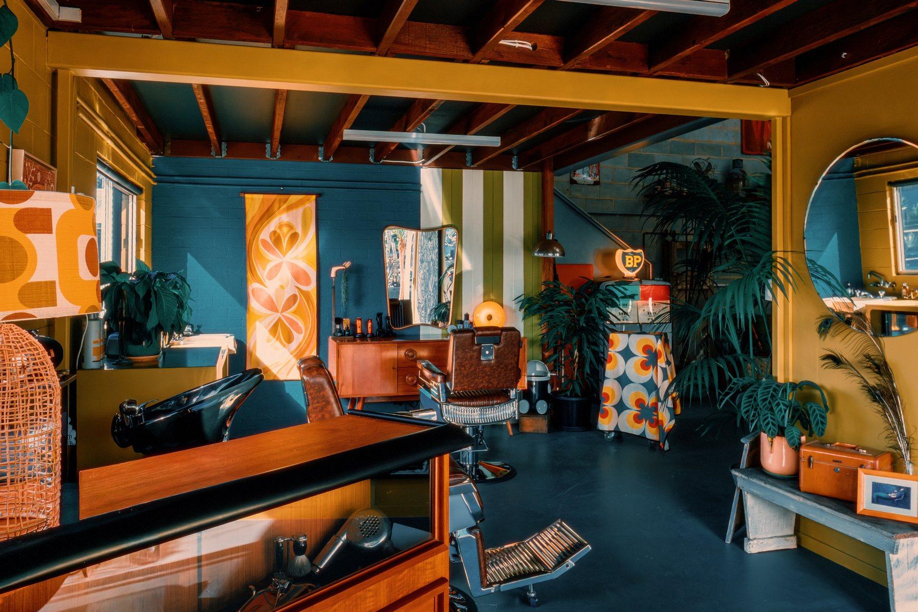 Wide shot of the shop interior with a lit vintage BP sign, orange lamp and tropical plants