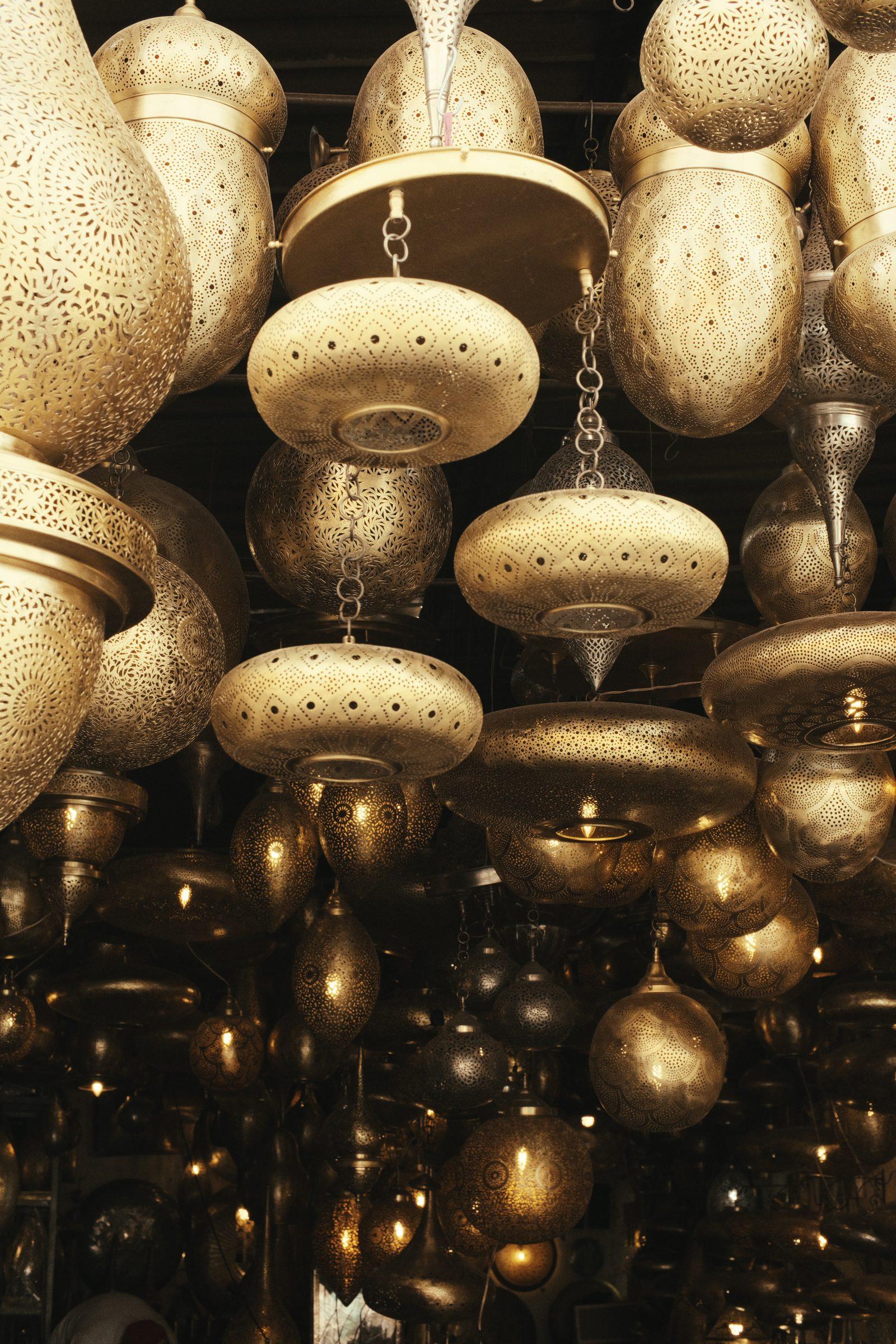 Rows of brass lanterns hanging in a shop