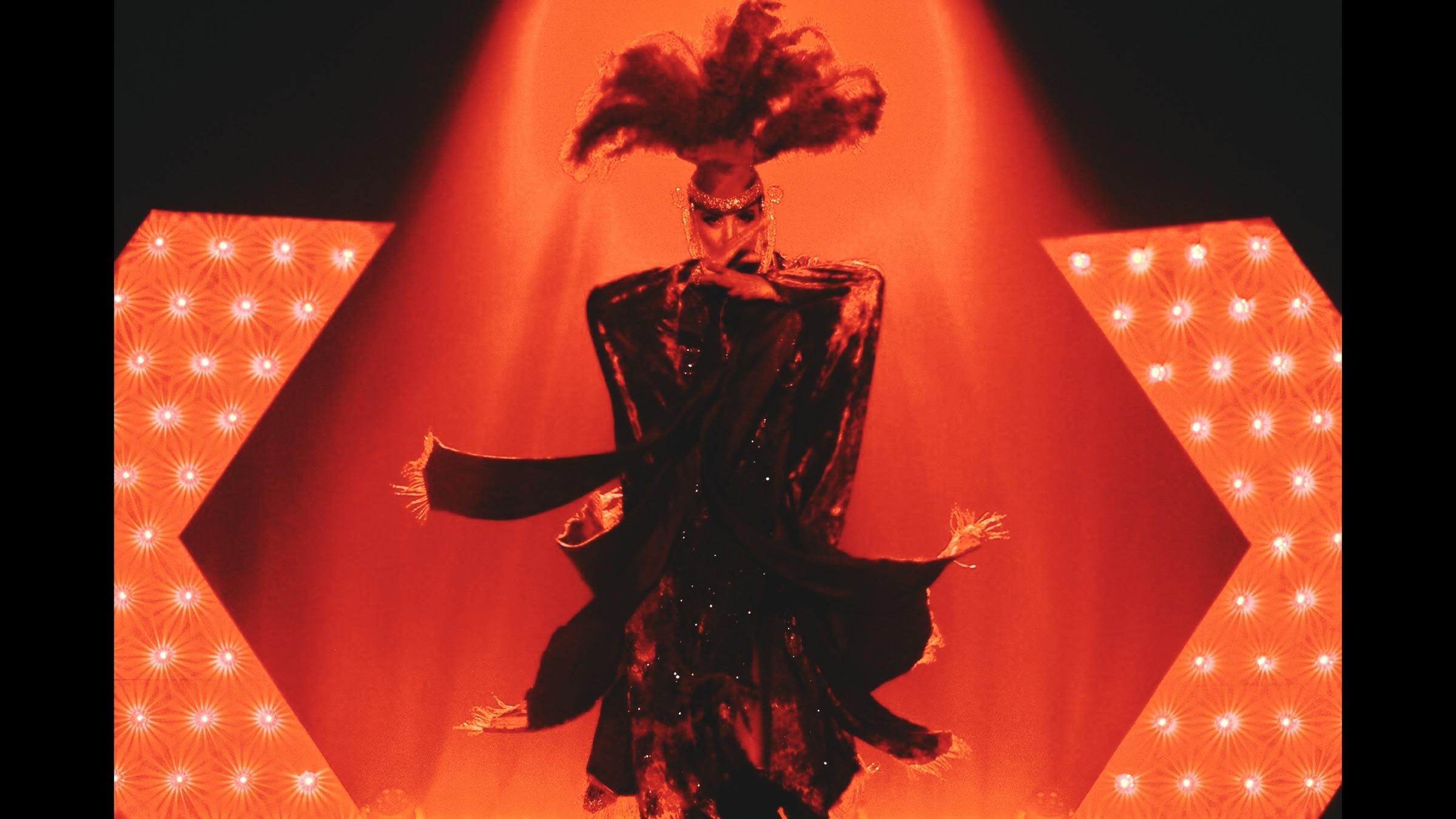 Performer mid-set under stage lights